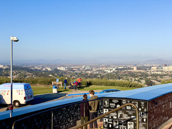 A monument with medals an photos at the top of a mountain in San Diego California