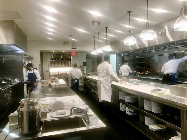 A couple of chefs working in the kitchen of Thomas Keller's Bouchon Las Vegas