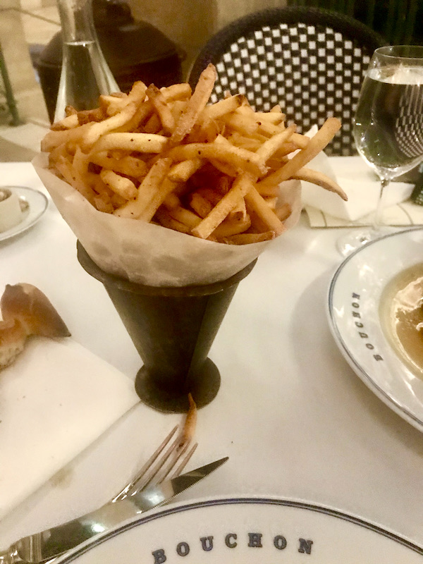 A cone of French Fries sitting on a white tablecloth at Thomas Keller's Bouchon Las Vegas