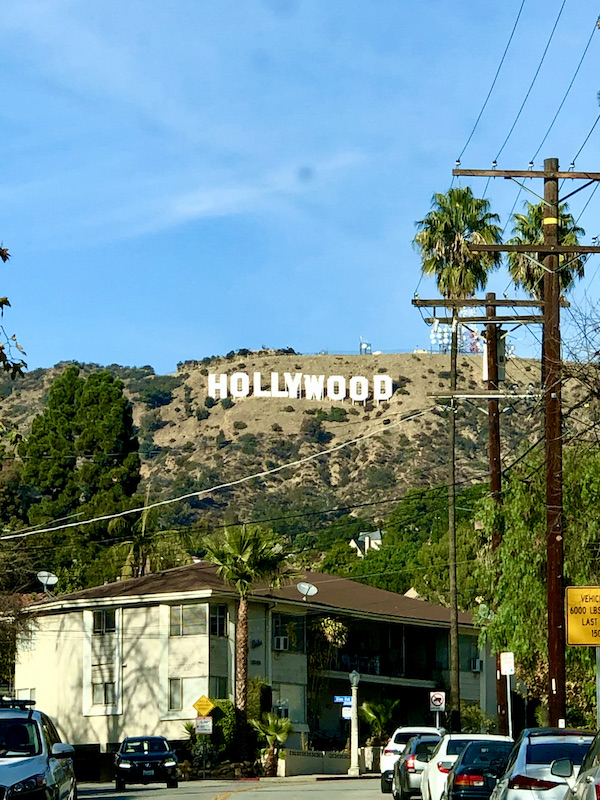 A mountain with white letters spelling HOLLYWOOD seen during A Day in LaLa Land