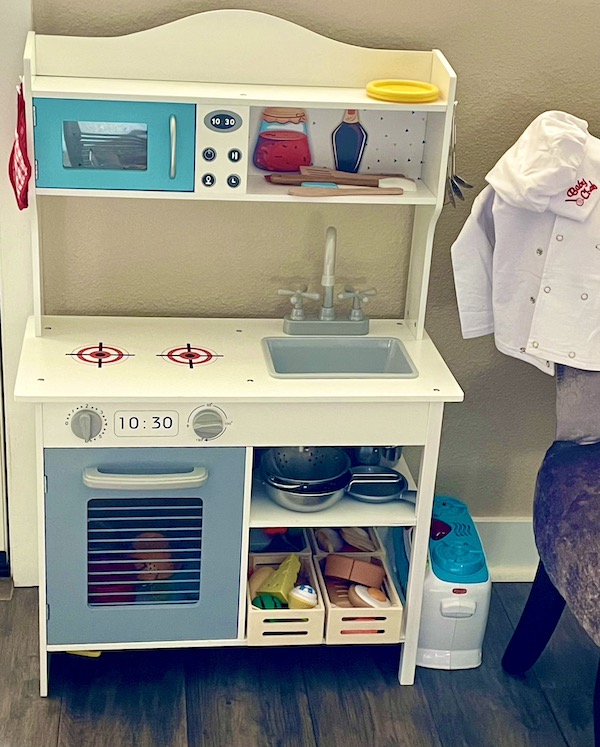 A toy kitchen and a child's chef coat and hat seen during A Day with Friends in Windsor California