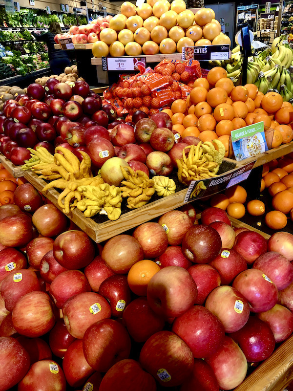 A market display of apples and citrus with odd shaped lemons found during A Day with Friends in Windsor California