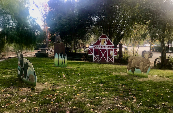 A red barn "Casa de Barn" with cut outs of sheep and other farm animals at Casa de Fruta Hollister California