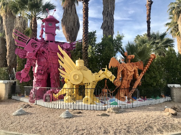 A property with colorful metal sculptures in front near Great Shakes in Palm Springs California