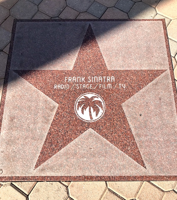 A pink marble square with a star in the center and a celebrity's name near Great Shakes in Palm Springs California
