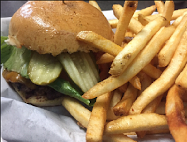 A burger and fries on white deli paper eaten for lunch near Joshua Tree National Park