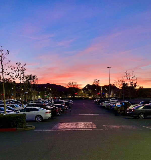 A purple and pink sunset over a parking lot near the Southern California Coast