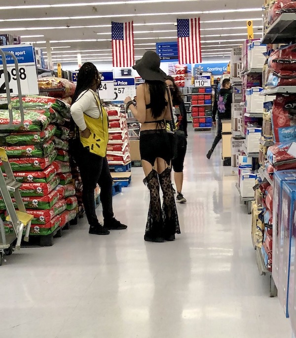 A woman in a bizarre black outfit shopping at Walmart near the Southern California Coast