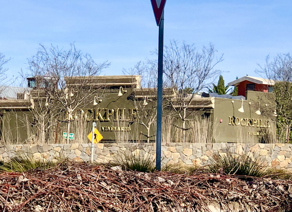 An olive green building that's Rockpile Vineyard tasting room seen through trees near where we had A Taste of New Orleans in Healdsburg CA