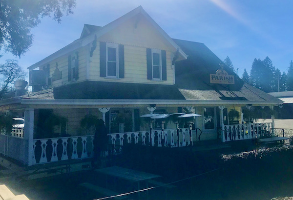 A light yellow building with iron fence that's a restaurant offering A Taste of New Orleans in Healdsburg CA