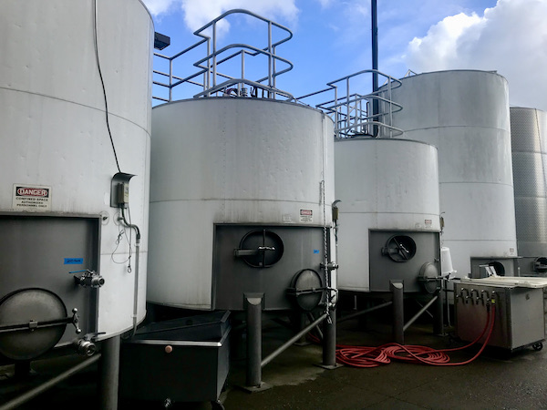Large white vats outside seen on our tour Behind the Scenes at Stuhlmuller Vineyards