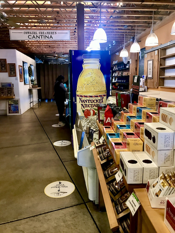 Inside a cheese shop with assorted boxes of crackers on display at a stop after Historic Point Reyes Lighthouse