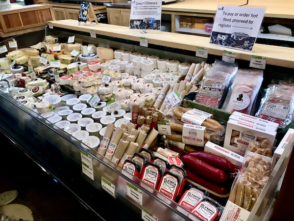 A huge cheese case with many cheese at a stop after the Historic Point Reyes Lighthouse