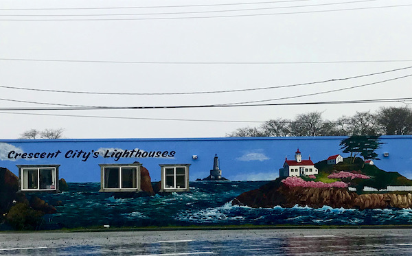 A colorful mural of a lighthouse and ocean near Jedediah Smith Redwoods Crescent City CA