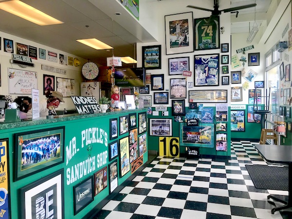 A sandwich shop with green counters, black and white checkered floor and lots of photos Petaluma to Point Reyes California