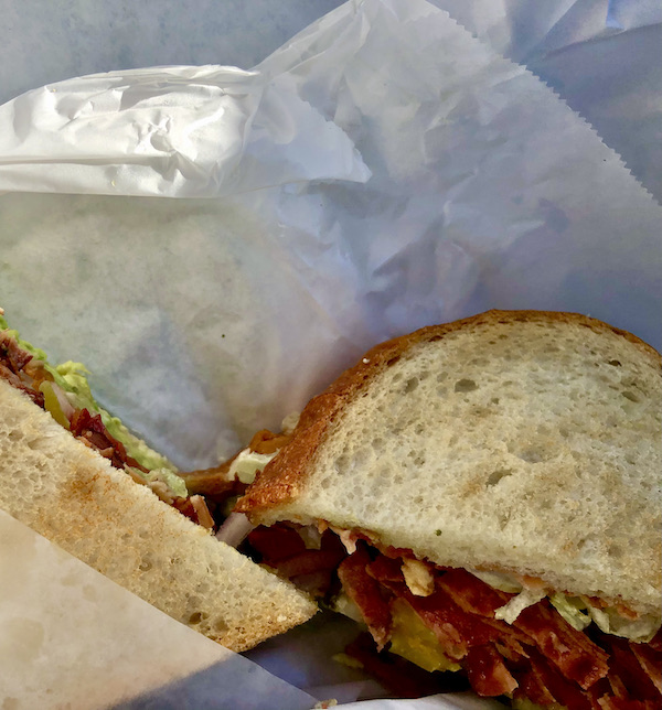A pastrami sandwich on rye with coleslaw. Sandwich sitting on crumpled deli paper Petaluma to Point Reyes California