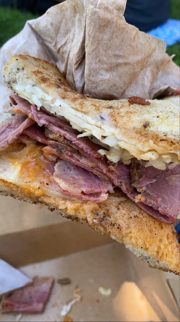 A half of a deli sandwich on rye bread eaten on a trip to San Francisco California
