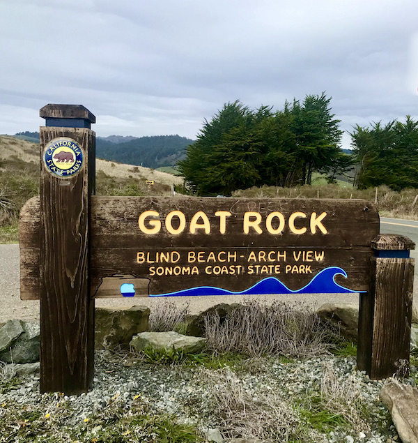 A brown wood sign welcoming you to Goat Rock at Sonoma Coast State Beach