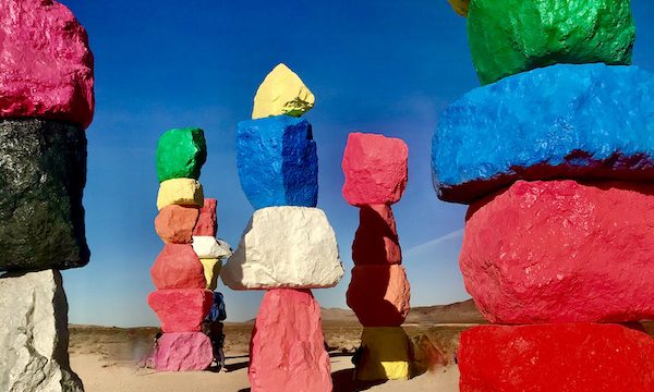 Seven pillars of stacked boulders each painted a different vibrant color. The assemblage is called 7 Magic Mountains and is one of the 15 Best Free Attractions Las Vegas NV