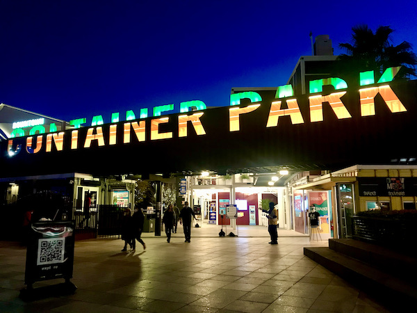 A red green and yellow striped sign for the Downtown Container Park, one of the 15 Best Free Attractions Las Vegas NV