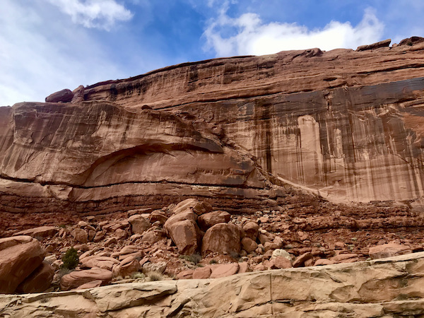 Red rock mountains with darker color appearing to drip down the sides at Arches National Park Moab Utah