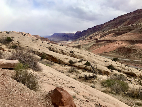 A crisscross of mountains with storm clouds rolling in at Arches National Park Moab Utah