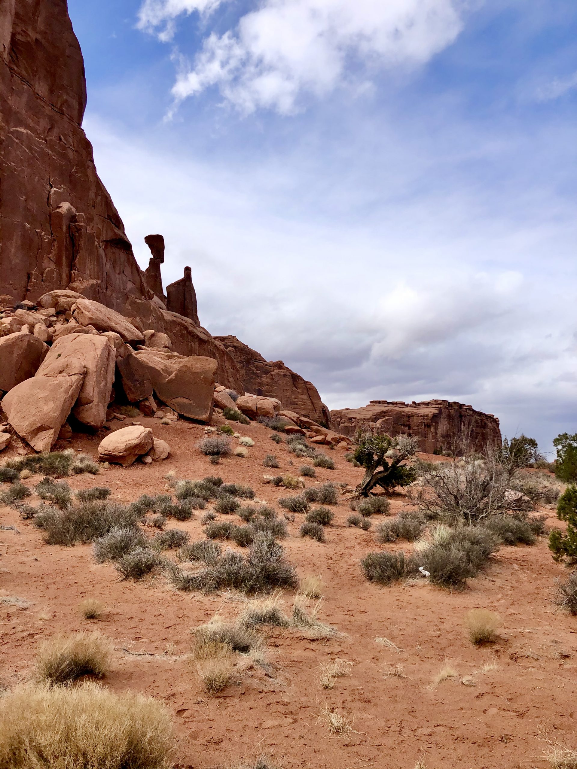 A tumble of rocks reveal two rocks that look like people conversing at Arches National Park Moab Utah