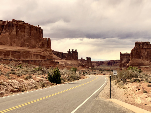 Highway through red rock mountains at Arches National Park Moab Utah