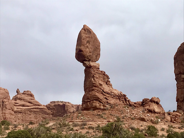A red rock jutting out of the ground with an egg shaped rock balanced on top at Our little guy, Hershi got a haircut today and feels much better about himself. Visit us at https://TheTravelingLocavores.com to follow all our adventures #rvlife #rvtravel #fulltimerv #lifeontheroad #rving #rvliving #Locavores #WeLoveFood #Foodies #TheTravelingLocavores #Wanderlust #Traveling #FoodTravel #TravelFoodBlog #TravelFoodie #FoodStories #TravelPhotography #yorkie #yorkielove