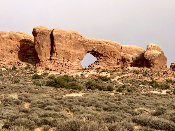 A very large rock with an arched key hole opening showing sky at Our little guy, Hershi got a haircut today and feels much better about himself. Visit us at https://TheTravelingLocavores.com to follow all our adventures #rvlife #rvtravel #fulltimerv #lifeontheroad #rving #rvliving #Locavores #WeLoveFood #Foodies #TheTravelingLocavores #Wanderlust #Traveling #FoodTravel #TravelFoodBlog #TravelFoodie #FoodStories #TravelPhotography #yorkie #yorkielove