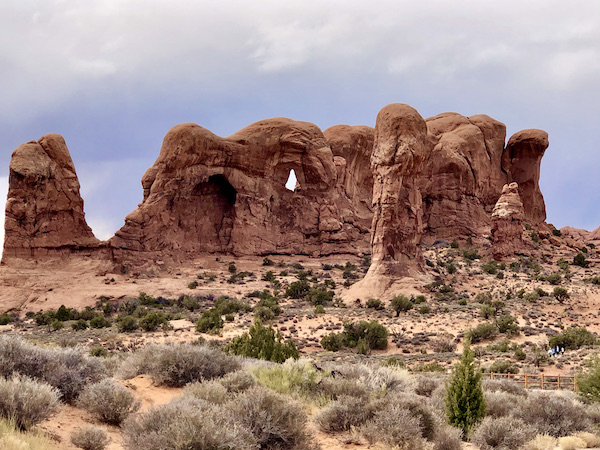 Red rock with a hole and lots of arches at Our little guy, Hershi got a haircut today and feels much better about himself. Visit us at https://TheTravelingLocavores.com to follow all our adventures #rvlife #rvtravel #fulltimerv #lifeontheroad #rving #rvliving #Locavores #WeLoveFood #Foodies #TheTravelingLocavores #Wanderlust #Traveling #FoodTravel #TravelFoodBlog #TravelFoodie #FoodStories #TravelPhotography #yorkie #yorkielove