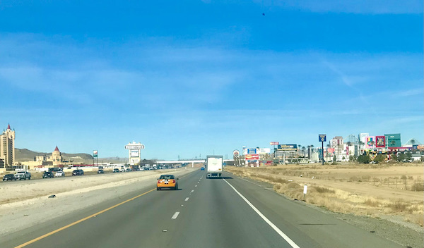 A highway flanked with stores and casinos on the way to Fremont Street Experience Las Vegas NV