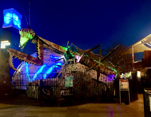 The exterior of a shopping center lit in blue, turquoise and lime green near the Fremont Street Experience Las Vegas NV