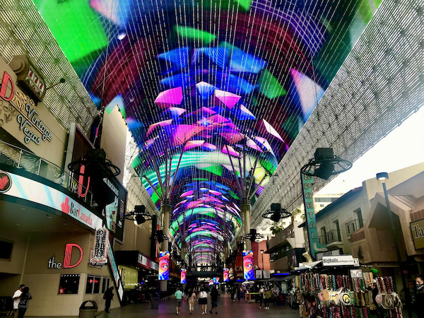 A mall with a domed video screen with vibrant colors at the Fremont Street Experience Las Vegas NV