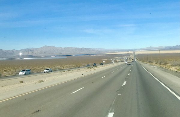 A highway flanked by desert and blue sky on the way to Fremont Street Experience Las Vegas NV