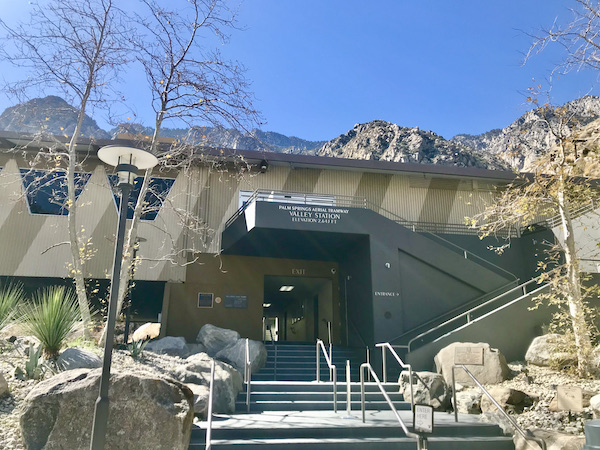 The entrance to a building at the top of outdoor steps with railing at the Palm Springs Aerial Tramway California