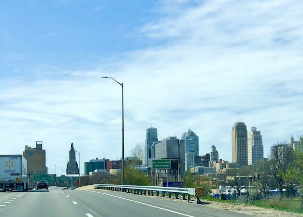 The skyline of a big city with tall buildings seen from the highway.