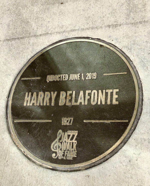 A bronze and gold round plaque on the Jazz Walk of Fame