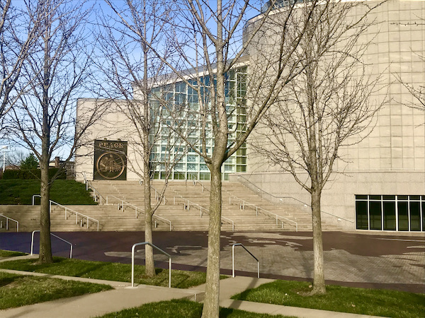 A beige and glass block building with barren trees in front is one of the Attractions in Independence Missouri