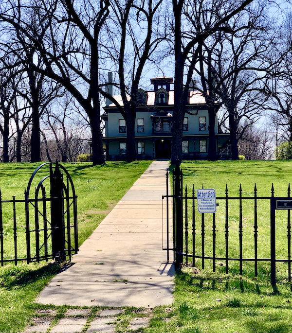 An open wrought iron gate leads to a large estate and is one of the Attractions in Independence Missouri