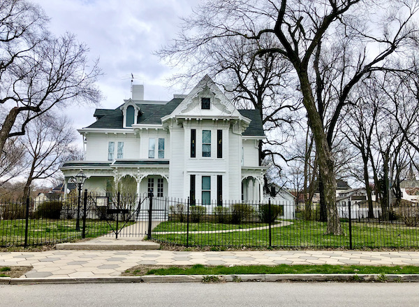 A white two story house with a front porch in one of the Attractions in Independence Missouri