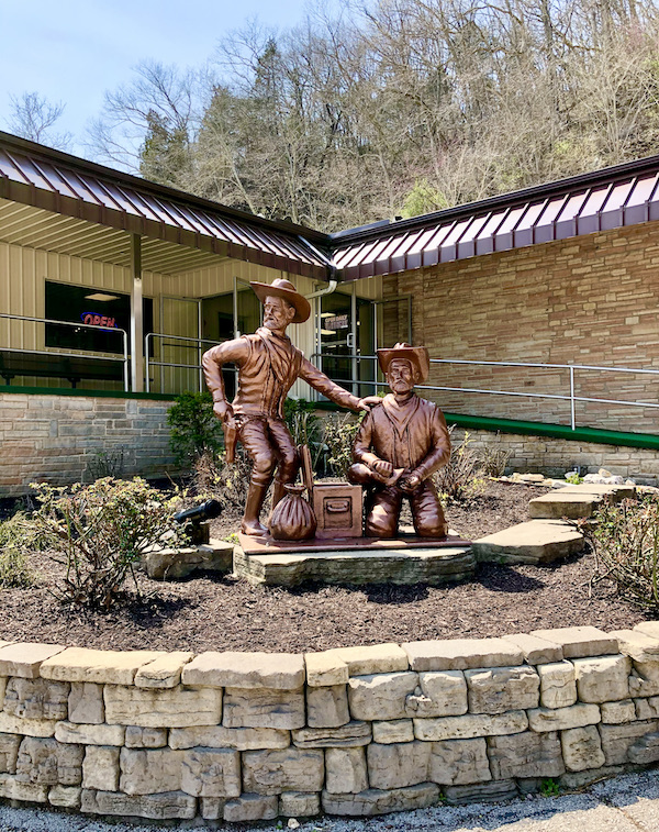 A copper colored pair of statues of two outlaw cowboys at Meramec Caverns Stanton Missouri