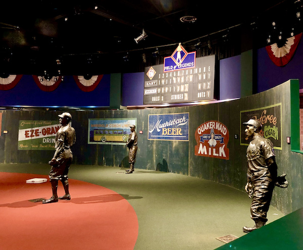More statues of baseball players on a ballfield complete with scoreboard at the Negro Leagues Baseball Museum
