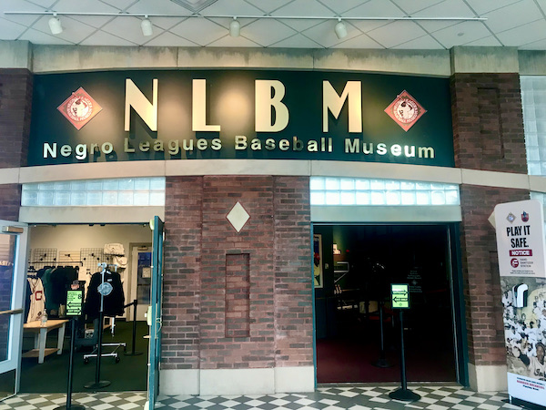 The entry to the Negro Leagues Baseball Museum with wood and black and white checkered floor.