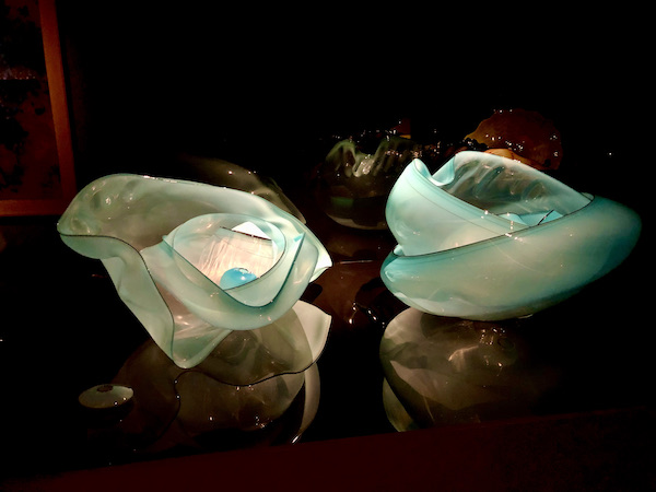 Aqua opalescent glass bowls stacked inside each other. Two stacks side by side at the OKC Museum of Art Dale Chihuly Exhibit