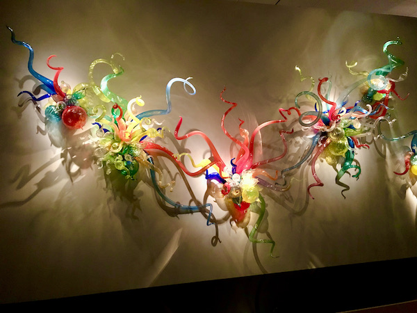 Colored blown glass worm like tubes on a wall at the OKC Museum of Art Dale Chihuly Exhibit