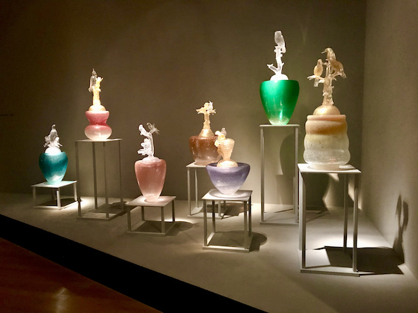 A series of glass sculptures on different height pedestals at the Oklahoma City Museum of Art