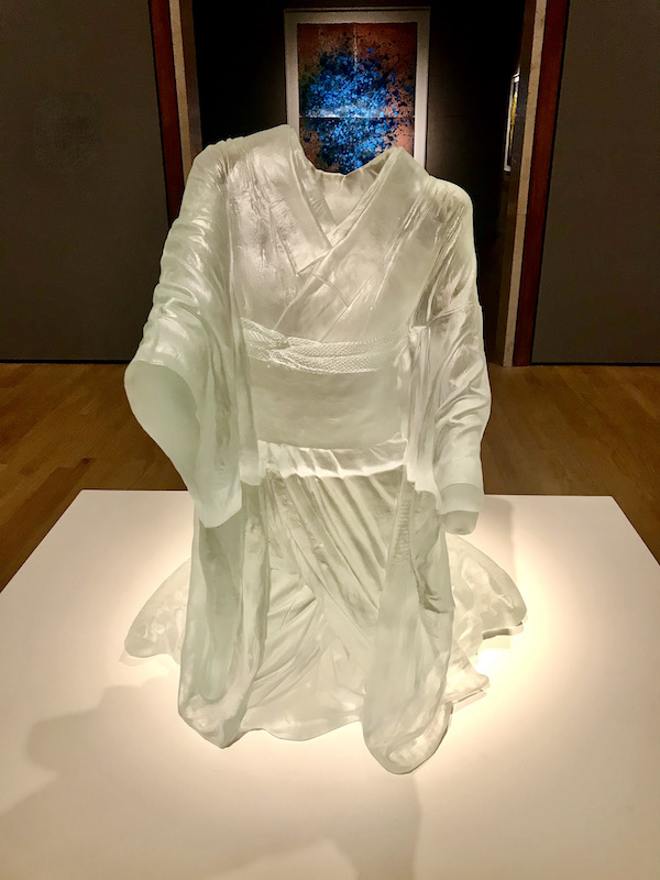 A kneeling figure in a kimono made of cast glass at the Oklahoma City Museum of Art