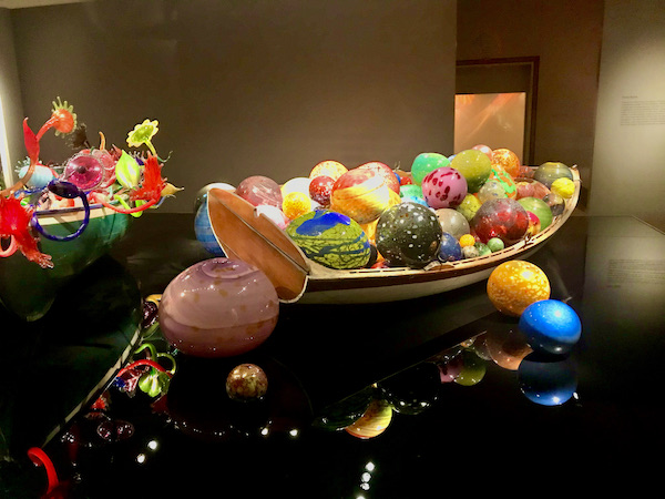 A display of boats filled with glass objects at the Oklahoma City Museum of Art