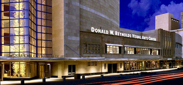 The facade of a huge building with glass entry is the Oklahoma City Museum of Art